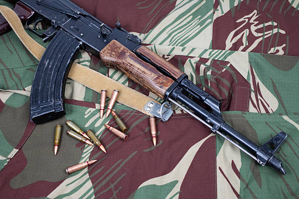 istock AK assault rifle on camo uniform background 2202702225