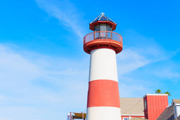Oceanside, California - December 27, 2024: Prominent lighthouse in Oceanside, California with striking red and white stripes under a sunny sky.