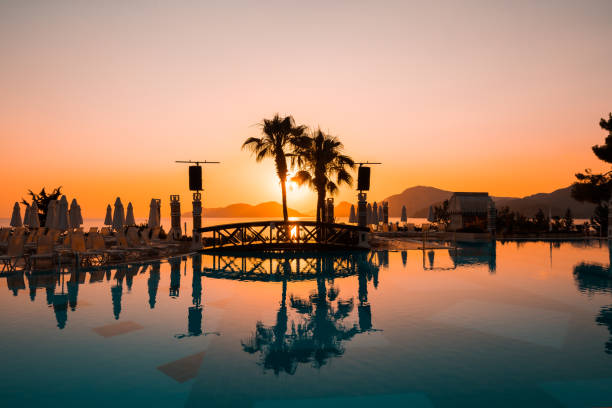 Umbrellas and sun loungers, like faithful squires, await their owners at dawn. In a soft chaise lounge chair, under the openwork shade of an umbrella, time slows down, giving way to bliss.