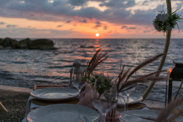 istock A beautiful sunset dinner setup on the beach, just a few steps from the sea. 2202712199