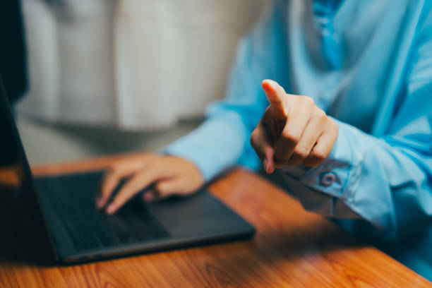 istock Business professional pointing at screen while working on laptop in office setting, Business concept. 2202713532