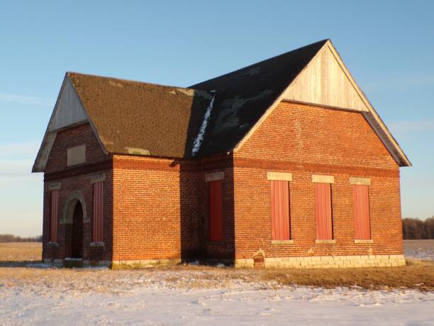 istock Red abandoned building on sunny day with blue sky. 2202723471