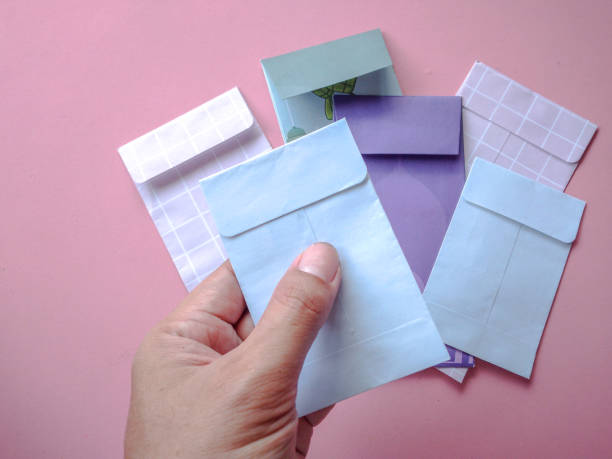istock Asian little child's hand holding gift envelope. 2202730063