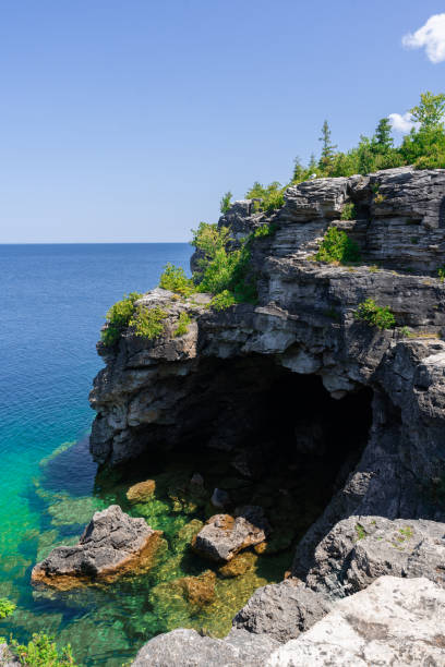 istock nature scene from Tobermory, Canada, with vibrant blue waters, rocky cliffs, and lush greenery. 2202730577