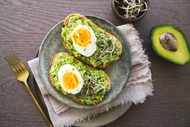 Tasty Avocado Toast with Poached Eggs on Plate