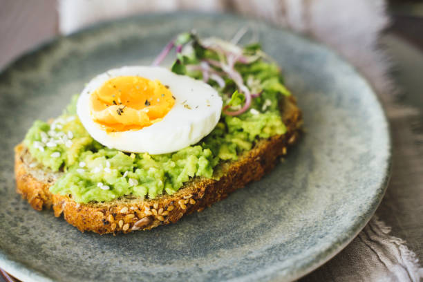 istock Fresh Avocado Toast with Egg and Microgreens 2202730622