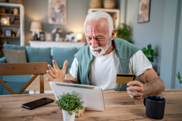 istock Senior man using digital tablet and credit card for online shopping at home 2202734310