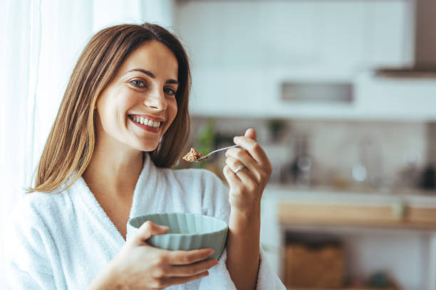 istock Smiling Woman Enjoying Healthy Breakfast in Modern Kitchen Setting 2202738594