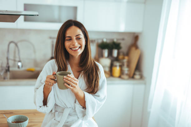 istock Woman Enjoying Morning Coffee in Cozy Modern Kitchen Setting 2202738663