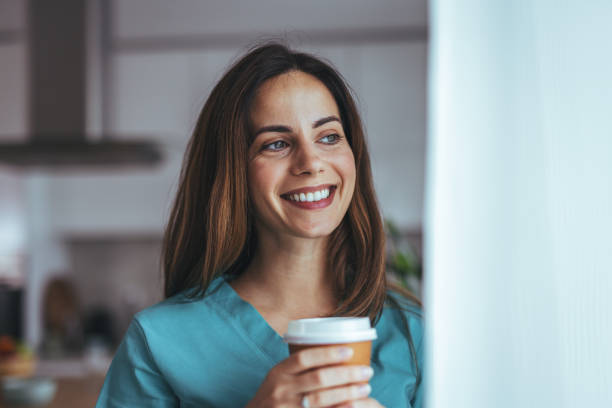 istock Smiling Woman Enjoying Coffee Break In A Comfortable Home Setting 2202738680