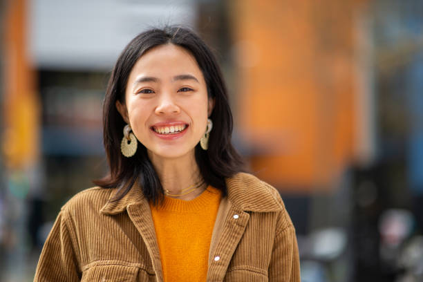 istock smiling young chinese woman looking at camera 2202739135