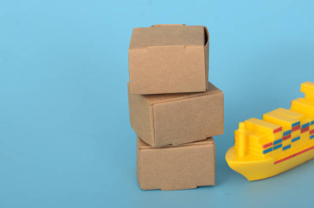 istock Visual Representation of Goods Transport Using Simple Boxes & Toy Ship 2202739424