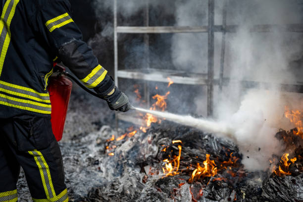 istock Firefighter Extinguishing Flames in Protective Gear 2202739580