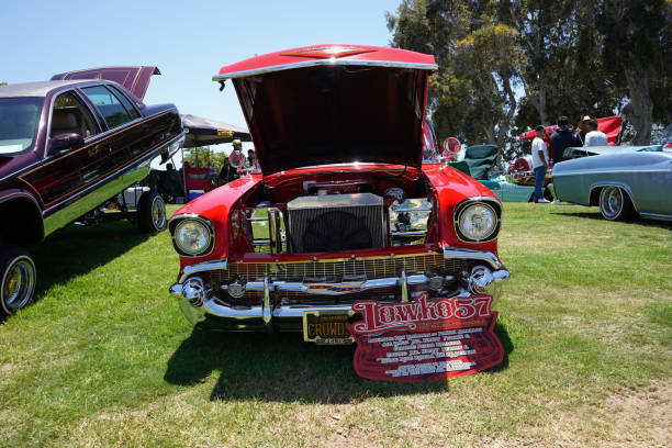 Close up of red  classic car chrome hood design element front view.