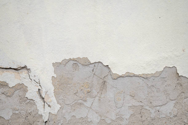 istock Cracked and peeling paint on an old wall 2202748826