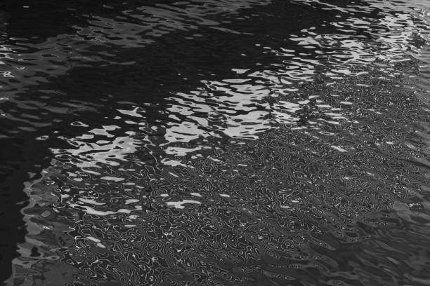 istock Light reflecting off rippled water 2202749469