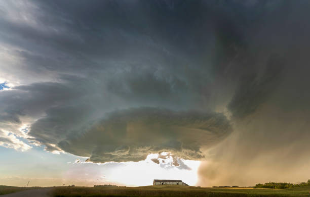 istock Supercell storm clouds forming over farm at sunset 2202750960