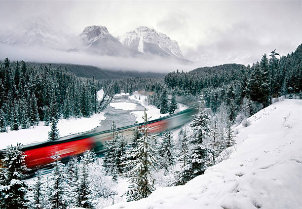 istock Red train passing through snowy banff national park in winter 2202750968