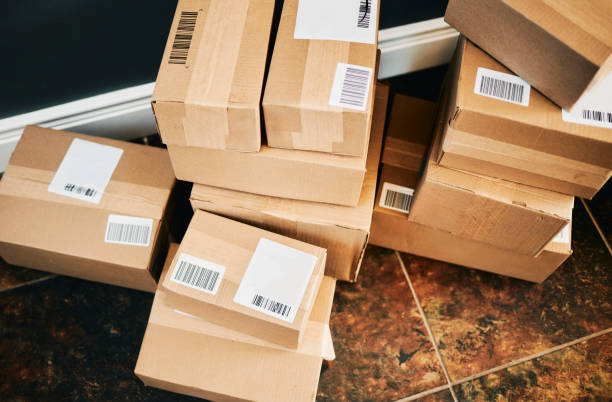 istock Stack of Cardboard Delivery Boxes On the Floor 2202751043