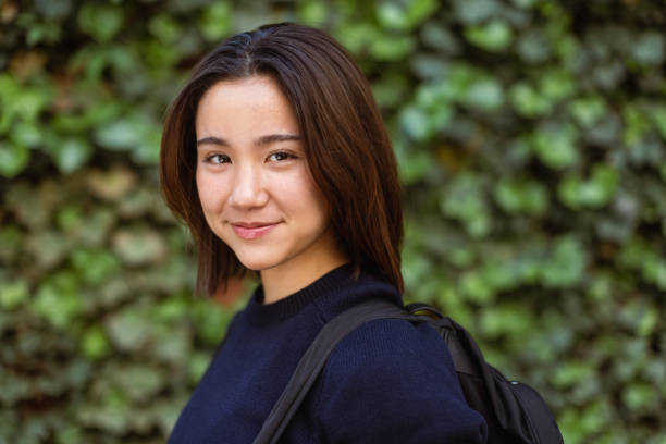 istock Young Woman Smiling Outdoors in Daylight 2202751233