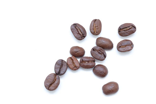 Top view of brown coffee beans on white background,