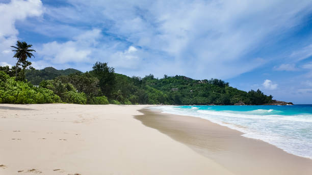 istock Secluded tropical beach with turquoise ocean and lush greenery. Seychelles, Mahe. 2202763359