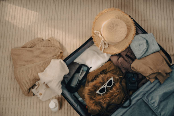 istock Pack clothes and stuff in luggage for travel on holiday. 2202763396