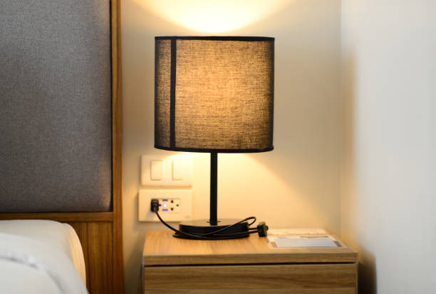 istock Reading lamp on the bedside table in an apartment Comfortable hotel 2202763844