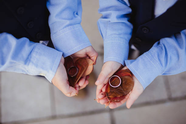 Little boys as ring bearers holding wedding rings in their hands