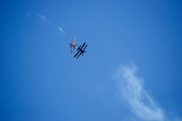 istock aerobatic planes doing a maneuver in which they pass together 2202770030
