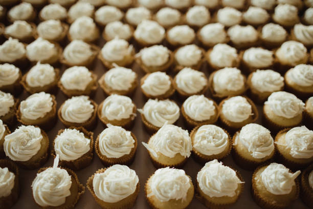 istock Rows of cupcakes on dessert table at wedding reception 2202770039