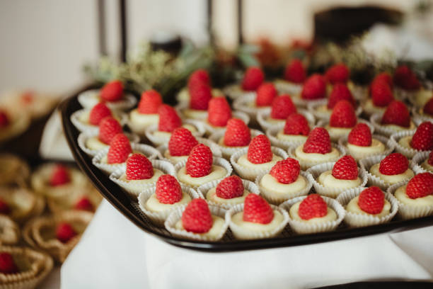 istock Tray of mini cheesecakes with raspberry topping 2202770440