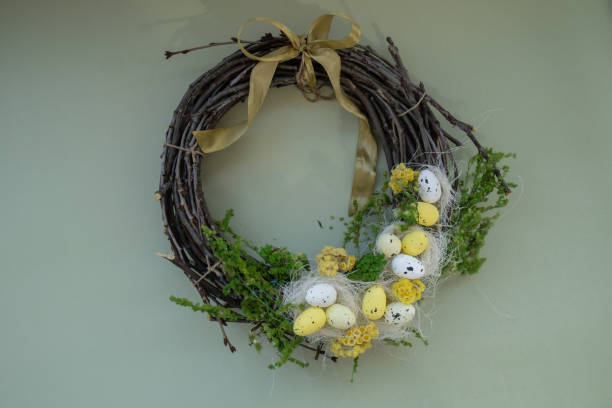 istock Handmade Easter wreath festive yellow egg decorations. Traditional holiday preparation craft creative decor. Sustainable responsible holiday gift workshop creation. Copy space Simple ideas 2202770598