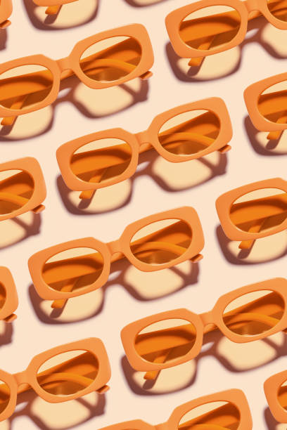 istock Pattern of Trendy sunglasses with Yellow Frame on peach background, beach vibes, summertime mood, sunlight shadow, Summer vacation, summer rest concept. Minimal style layout of eyeglasses 2202772008
