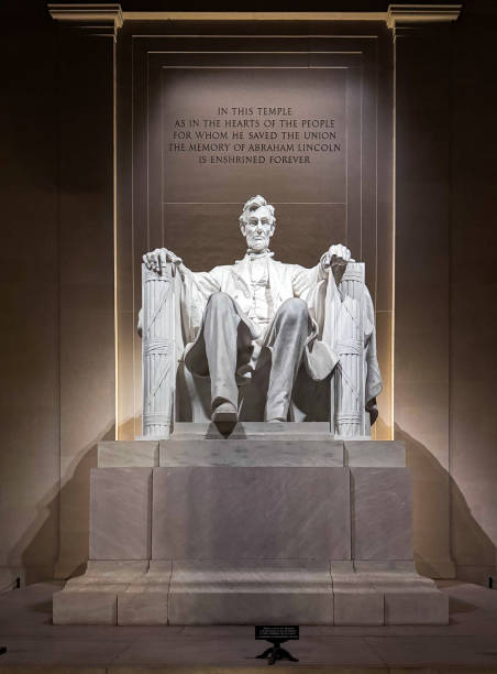 Bright lights shine on a statue of Abraham Lincoln
