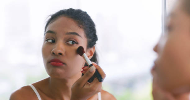 istock black woman use facial brush 2202773280