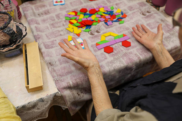 istock Elderly hands playing social games in a nursing home, close-up 2202776499