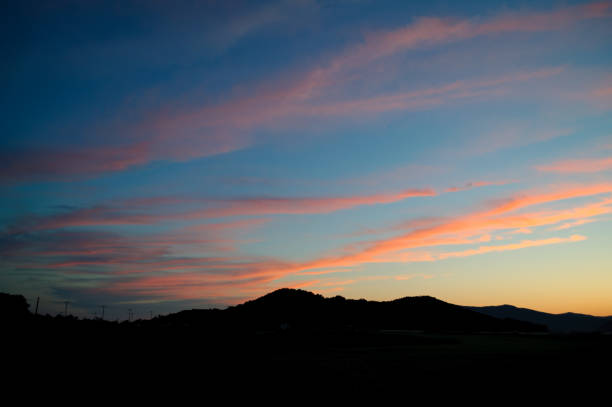 istock Clouds and country scenery in the evening sunset. 2202776980
