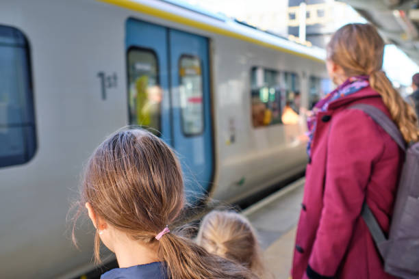 Changsha City, Hunan Province, China - August 18, 2024: A woman and her child prepare to board the train on the platform of Changsha Railway Station