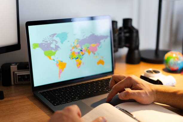 istock Traveler planning next trip using laptop and world map 2202784637
