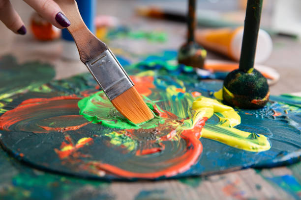 A vibrant and lively scene of paint mixing vividly on a canvas, showcasing colorful strokes and intricate brushwork