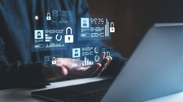 istock Cybersecurity concept with digital data icons floating above hands in front of a laptop. 2202786654