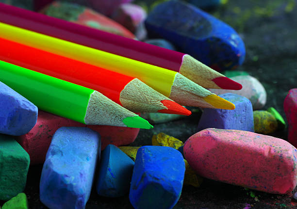 multicolored pastel crayons and colored pencils close up