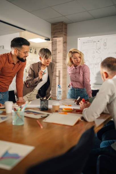 istock Marketing team analyzing charts and developing new strategy during brainstorming meeting 2202789102