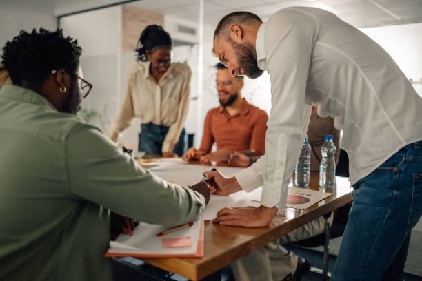 istock Marketing team analyzing statistics and developing strategy in office meeting 2202789103