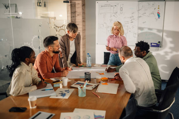 istock Marketing team analyzing diagrams and discussing new strategy during a meeting 2202789123