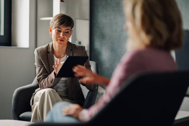 istock Financial advisor showing information on tablet to client 2202789162