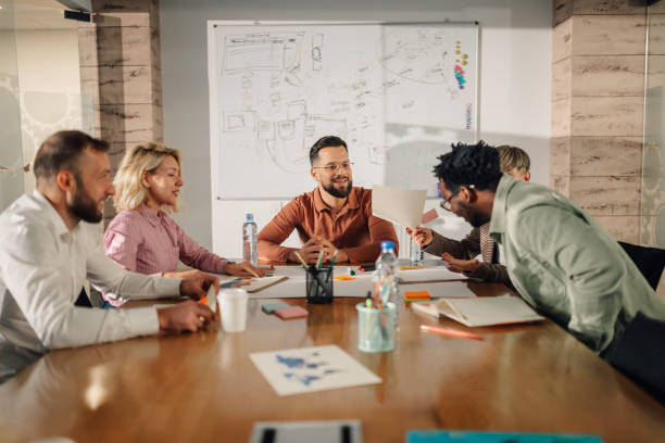 istock Marketing professionals collaborating on project during team meeting 2202789206