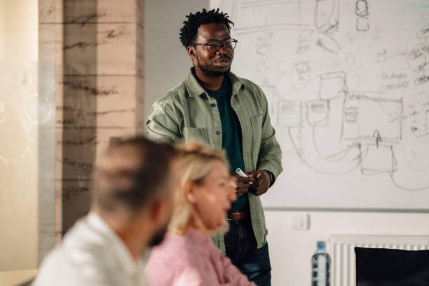 istock Project manager leading a brainstorming session with coworkers 2202789211