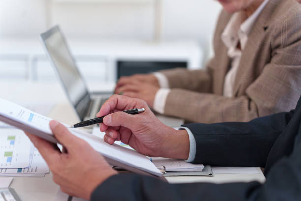 istock Senior business professionals analyzing financial data together, reviewing reports and discussing investment strategies in a modern office. 2202792383